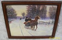 Framed winter sleigh ride oil painting depicting a horse pulling a sleigh with two riders on a snowy road, surrounded by snow-covered trees, signed B. Warner in lower right corner.