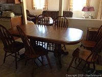 Full set: dining table with leaf installed and six chairs in kitchen/dining area