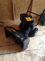 Front‐angle view showing auger housing, chute and frame