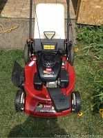 Front view showing red deck, Toro Recycler decal, black engine housing, grass chute.