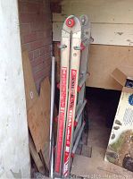 Side view of folded American Titan ladder showing brand labels and locking hinges.