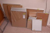 Group shot of frames leaning against wall showing assorted sizes