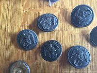 Top view of six Civil War US Marine Corps buttons showing eagle with anchor design