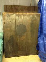 Front view of larger barn wood panel with weathered stains and color variations. Visible nail holes and wood grain.