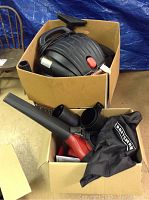 Wet dry vacuum and blower vac packed in original boxes, showing vacuum top and blower vac nozzle and dust bag.