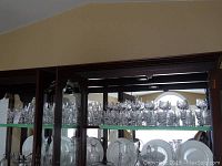 Wide shot of mirrored hutch shelf displaying full assortment of cut crystal stemware