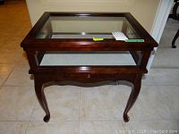 Front view showing entire table with glass top, drawer closed