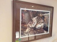 Front view of framed art print showing wolves in forest