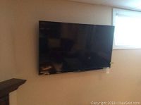 Front view of Toshiba 46 inch TV mounted on the wall.