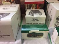 Three Department 56 Heritage Village Collection Dickens’ Village Series boxes showing Horse Drawn Hearse, Wrenbury Baker, Regent Park House