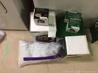 Overview of all four boxed figurines with packing materials
