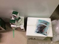 Overview: three Department 56 boxes, zip-lock bag of bulbs beside styrofoam base