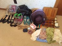 Overall lot showing sandals, shoes, scarves, hats, jewelry boxes, and small accessories on carpet.