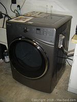 Front-left angle view of dryer showing exterior condition and door