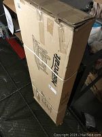 Cardboard box with Mastercraft branding and assembly illustration, sealed with tape and plastic strapping.