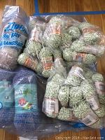 Photo showing multiple skeins of Bernat Cotton Twists yarn in green/white color and Bernat Naut Heather yarn in a blue/purple/multi colorway inside plastic bags