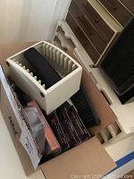 Photo of plastic storage box holding cables and accessories