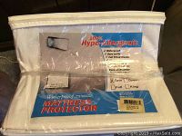 Front view of packaged mattress protector showing 100% hypoallergenic, waterproof, full fitted elastic for twin size.