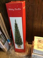 Photo of the boxed 3-foot fiber optic Christmas tree in original packaging labeled 'Holiday Novelties'
