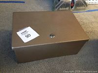 Top view of the metal fire safe showing lock cylinder and textured surface.