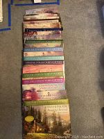 Stack of Thomas Kinkade calendars showing several Special Collector's Edition covers with landscape artwork.