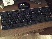 Logitech wireless keyboard and mouse in front of Toshiba monitor stand