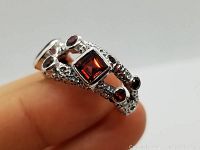 Close-up of the red garnet 925 sterling silver multi stone ring showing mixed garnet cuts and textured band detail.