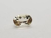 Close-up front view of the oval white sapphire showing its clarity and faceting.