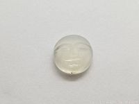 Front view of the round white moonstone with hand carved moon face design showing smooth polish, translucency, and minor inclusions.