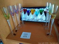 Set of 13 liqueur glasses displayed with 6 long stemmed clear glasses with colored rims and 7 short stemmed multicolored glasses in box