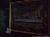Framed Last Supper decoupage print with golden frame and dark mat shown from front angle.