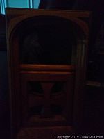 Image showing the tall rectangular wooden framed mirror with an arched glass top and carved cross design in the bottom solid wood panel.