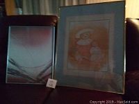 Framed prints displayed on a chair, showing the Modern Mood print and partially the Teddy Bear print.
