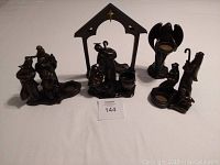 Full view of five-piece nativity set showing all figures and stable on white background.