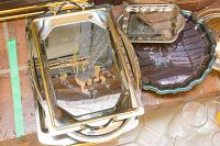 Photo showing metal trays including a rectangular tray with deer etching and an oval scalloped tray, plus part of the lidded bowl.