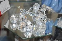 Front angle showing multiple crystal animal figurines including mice and a bird along with a miniature golf bag and clubs