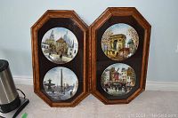 Two framed sets of Limoges porcelain plates featuring Paris scenes, showing all four plates and wooden frames