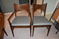 Two chairs (one armchair and one side chair) front view showing frame and seat fabric