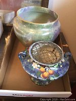 Both vase and urn together with visible metal flower frog in urn