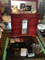 Overall view of wooden jewellery box, assorted jewellery boxes and glass heart dish on tabletop