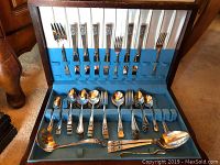 Full flatware set with 31 matching Community Plate pieces and 19 mismatched pieces of Rogers A1 Plus by Oneida, Oneida Community Par Plate and Electroplated Nickel silver, arranged in blue lined slots inside a wooden case.