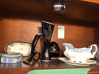 Overview photo showing three cobalt blue vases with gold trim, Johnson Brothers white gravy boat on attached tray, Wedgwood blue jasperware trinket dish, and a small Nippon tray.