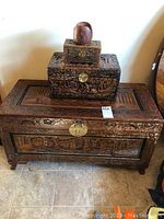 Front view of the three items stacked showing large trunk, jewelry box, and wooden coaster set