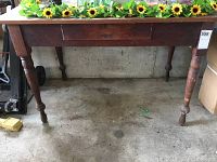 Front view of the vintage wooden table showing the full table with doweled legs and drawer front.