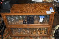 Front view of two glass-door compartments showing empty cabinet structure with reflections on glass.