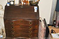Full view of the gentleman's slant top desk showing the double barrel front drawers and slant top closed surface.