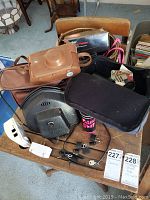 Photo showing multiple vintage cameras, leather camera cases, a Vivitar 278 flash, and various camera accessories.