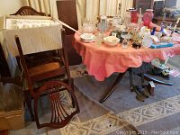 View of disassembled chairs and table near round table with assorted items