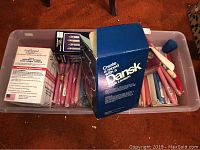 Plastic bin containing new assorted candles, candlelight warmer, emergency utility candles, and boxed Dansk Café Lantern