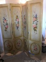 Front view of the four connected wooden panels featuring painted flowers and gold accents.